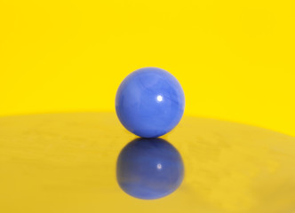 Blue ball on yellow background