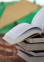 stack of books on city background