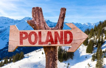 Naklejka premium Poland wooden sign with winter background