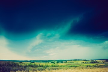 Fototapeta na wymiar Vintage photo of storm clouds over wheat field
