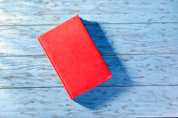 Red book on a blue table