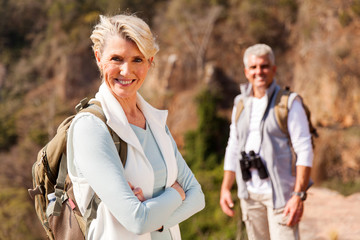 senior female hiker standing on mountain
