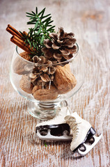 Obraz na płótnie Canvas Walnuts, pine cone, and cinnamon, Christmas decoration, holiday season, selective focus