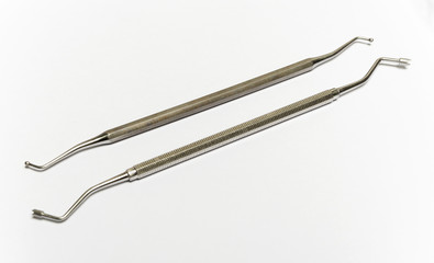 Chromed dental equipment on a blank white background. Two different ends of the dental tools.