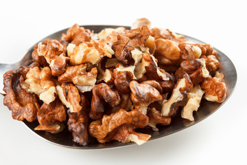 walnuts close-up in a metal spoon