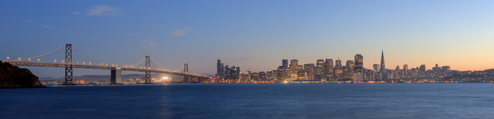 Fototapeta premium San Francisco – Oakland Bay Bridge with lights at sunset time