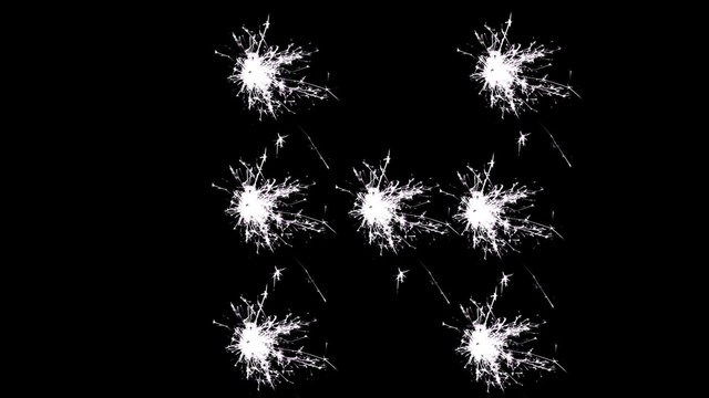 Capital letter H spelled with white sparklers on black background.