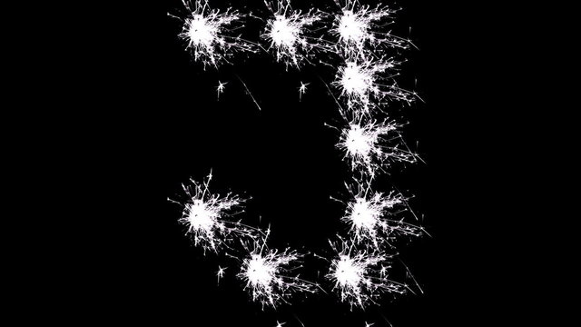 Capital letter J spelled with white sparklers on black background.