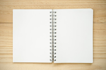 Notebook on wood background.