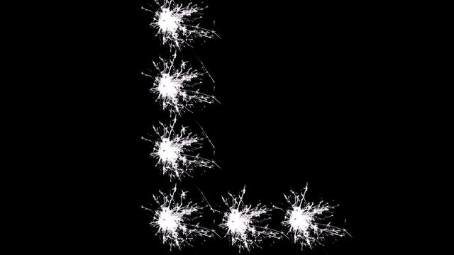 Capital letter L spelled with white sparklers on black background.