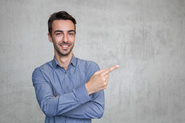 smiling business man pointing to the space right