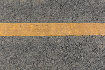 Fototapeta premium Yellow line dirty on black asphalt road texture