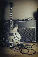 Obraz premium Guitar and Amplifier Vintage 2. Guitar and amplifier, shot with spot lighting and edited with a vintage filter.
