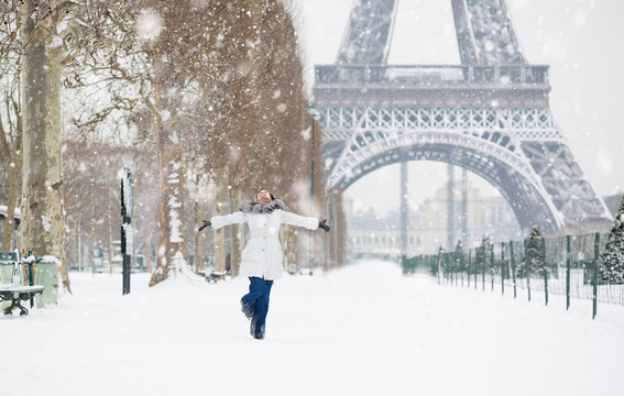 Winter in Paris. Happy young girl jumping