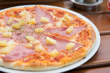 Tasty pizza with ham and cheese. Selective focus.