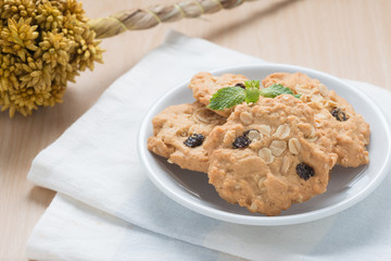 Oatmeal and raisin cookies on napkin.