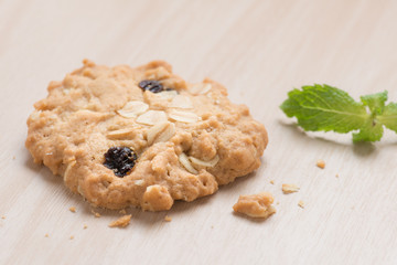 Oatmeal and raisin cookies on wood background.