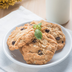 Oatmeal and raisin cookies with milk.