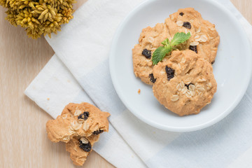 Oatmeal and raisin cookies on napkin.