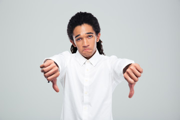 Afro american businessman showing thumbs down