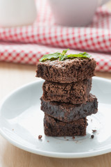 Chocolate brownies on white plate.