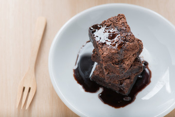 Chocolate brownies on white plate.