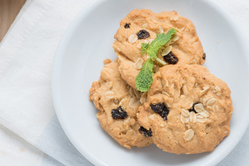 Oatmeal and raisin cookies on napkin.