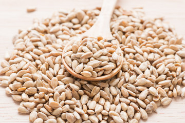 Sunflower seeds with a wooden spoon.