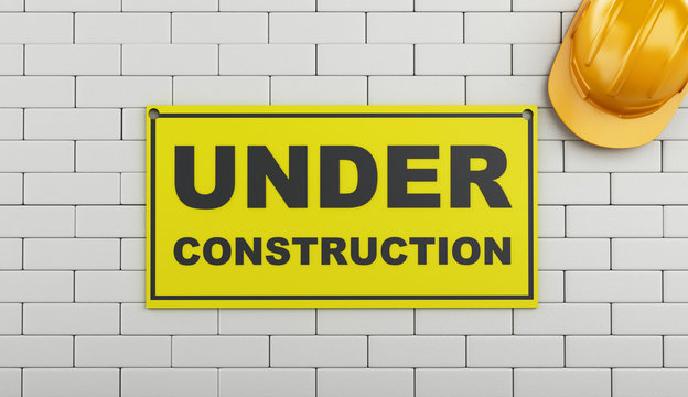 3d Under construction sign on brick wall.