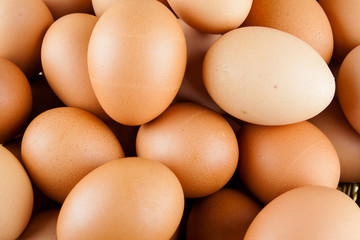 Full of Eggs put in a wicker basket in wooden background