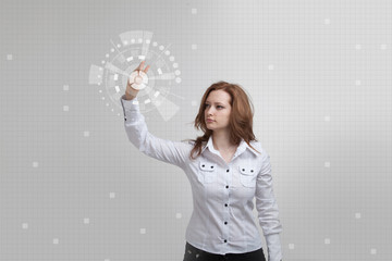 Young girl stands back and working with virtual screen