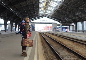 Traveling people, mother and child at the railway station