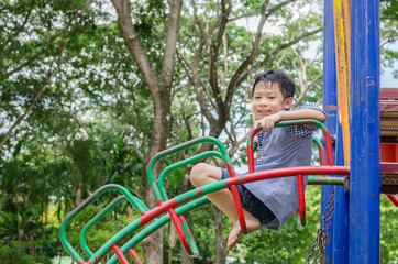 Fototapeta premium Little Asian boy playing at playground