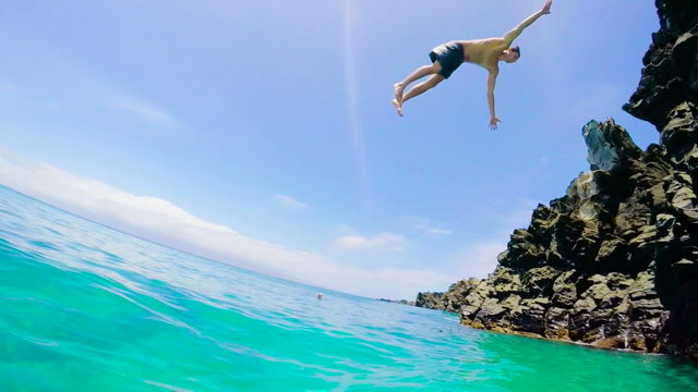 Extremely High POV Back Flip Cliff Jump into Water in Slow Motion. Summer Adventure Fun Lifestyle.