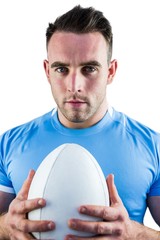 Rugby player looking at camera with ball