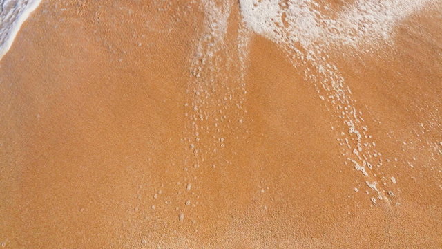 Vacation on the Beach. Close Up Shot of Waves Rolling Gently Up White Sand. 