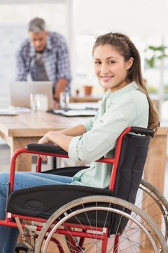 Smiling casual businesswoman in wheelchair