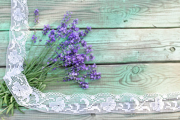 Bouquet of lavender with lace on wooden background