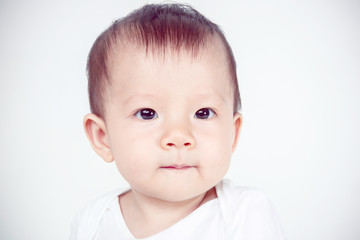 Asian baby girl smiling, studio shot (soft focus on the eyes)
