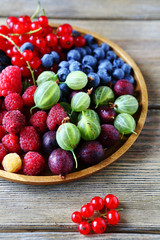 Fototapeta na wymiar summer berries on wooden plate