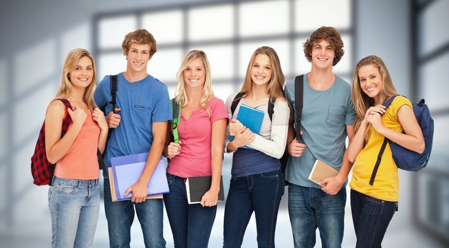 Smiling students wearing backpacks and holding folders