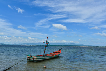 Fototapeta premium Clear blue sky with cloud and fishing boat in a shiny day.