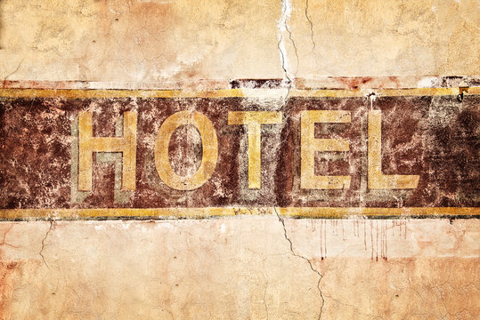 Old vintage hotel sign, painted on a wall
