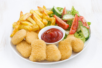 chicken nuggets, french fries and vegetable salad