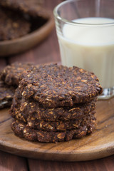 chocolate oatmeal cookies and a glass of milk, closeup
