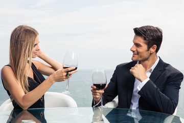 Beautiful couple drinking red wine