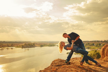 Couple in love. Passionate dance on the river bank.