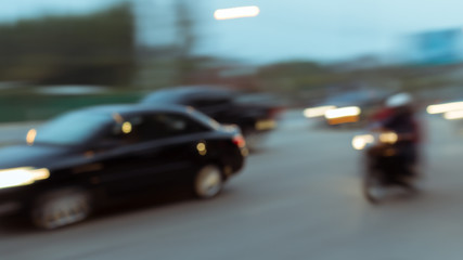 car and motorcycle driving on road with traffic jam in the city, abstract blurred