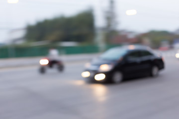 Fototapeta premium car and motorcycle driving on road with traffic jam in the city, abstract blurred