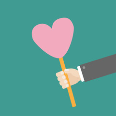 Businessman hand holding paper heart on the stick Flat design